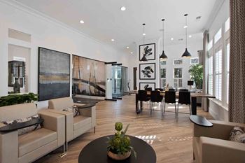 a living room and dining room with a table and chairs